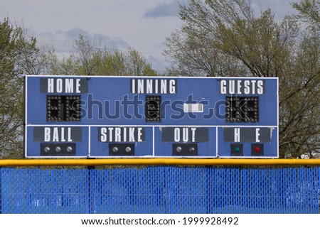 Blue scoreboard at a baseball field