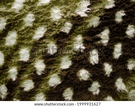 Animal print cloth texture presented with white dotted background.