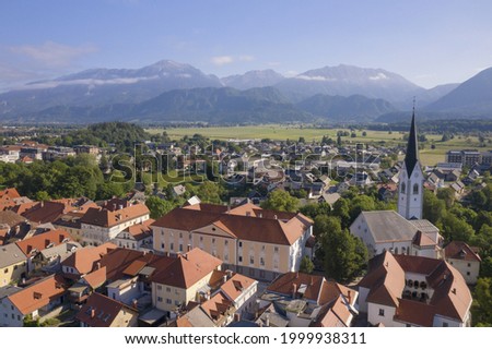 Old town with alps in the background Royalty-Free Stock Photo #1999938311