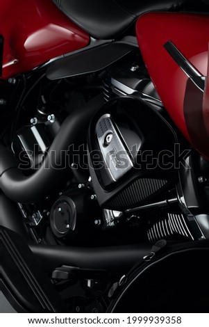 Beautifully lit red with chrome motorcycles, against a black background. advertising photography bike. Motorcycle for advertising. Chromed motor, detail bike