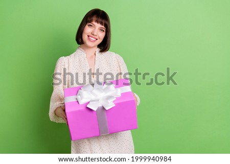 Photo of young attractive girl happy positive smile hold present box celebration isolated over green color background