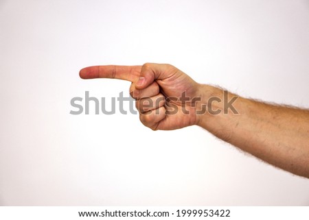 Thumb to the left. Man's hand and arms shows the direction to the left. Look over there. Hand of a Caucasian man on a white background and place for text. Copy space. Side view.