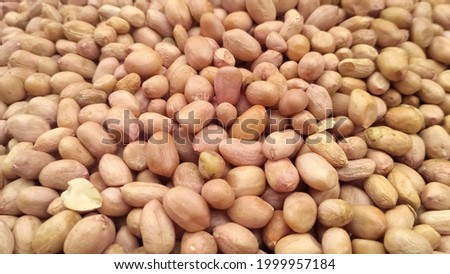 Close-up picture of ground nuts, peanuts seeds or dry nuts texture background.