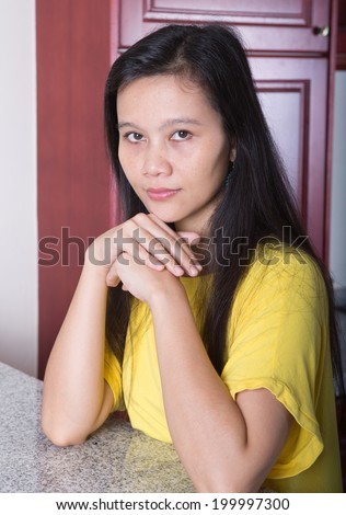Young Asian female in the kitchen