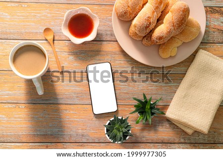 Breakfast and cell phone,Woman choosing picture online or in gallery during breakfast, blank screen for copy space