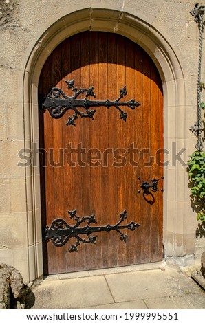 Entrance focus with wooden door with dark metal accents.