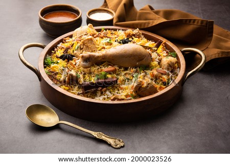 Restaurant style Spicy Chicken Biryani served with Raita and Salan, Popular Indian or Pakistani non vegetarian Food Royalty-Free Stock Photo #2000023526
