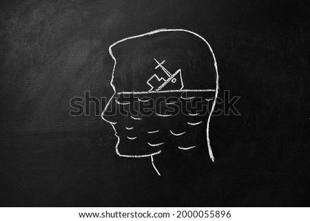 Broken hope concept. Silhouette of a human head drawn on a chalk board and a sinking ship of hope