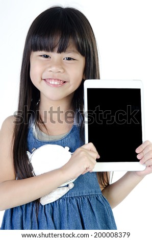 Little asian girl smiles with tablet computer on white background . 