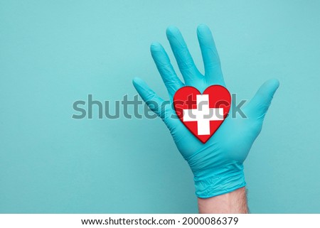 Switzerland medical health heart. Nurse hand holding country heart flag