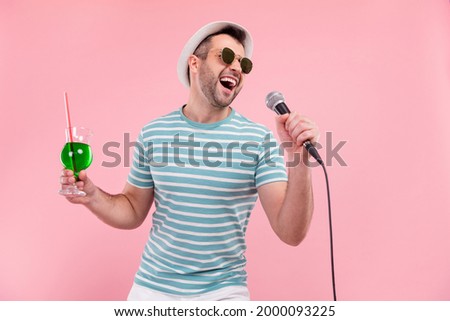 Photo of happy charming happy man hold hand microphone sign cocktail isolated on pink color background Royalty-Free Stock Photo #2000093225