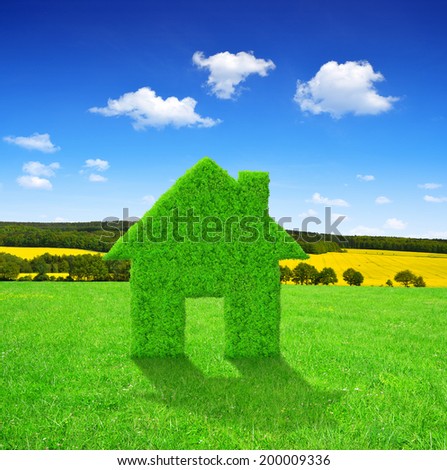 Green house symbol on meadow