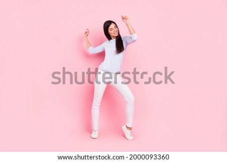 Full length body size view of attractive dreamy cheerful girl dancing having fun rest pastime isolated over pink pastel color background