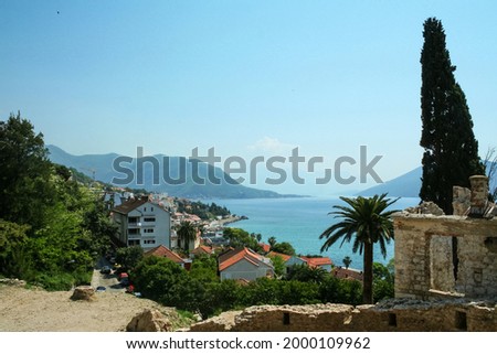 Panorama of the beach resort of Igalo with apartment buildings and holiday accommodation by the jadransko more sea. Igalo is a city of the Kotor Bay in Montenegro, next to Herceg Novi.

 Royalty-Free Stock Photo #2000109962