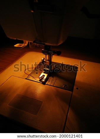 The electric sewing machine is taken in low light