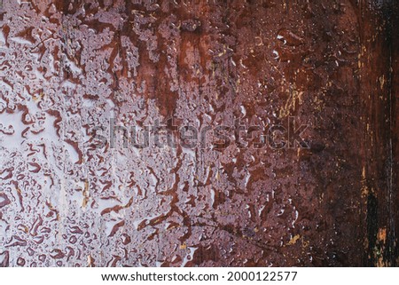 Close up water drops on a brown wooden surface during rain, abstract background, shallow depth of field
