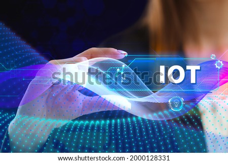 Business, Technology, Internet and network concept. Young businessman working on a virtual screen of the future and sees the inscription: IOT