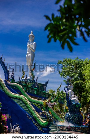 Background of Thailand's Chonburi religious attractions (Wat Khao Phra Khru viewpoint), with beautiful Buddha and Phaya Naga statues, tourists always come to make merit and take pictures at night.