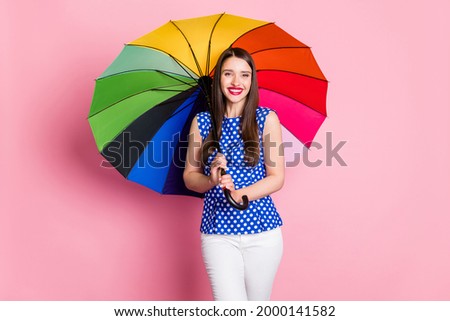 Photo of young cheerful woman happy positive smile hold colorful umbrella rain isolated over pastel color background