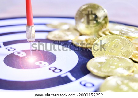The darts are placed in the center of the dart board where the bitcoins are placed.