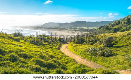 scenery over looking of Muriwai Beach from top of the hill one fine day Royalty-Free Stock Photo #2000169044