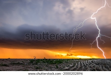 Lightning over a field in a thunderstorm. Thunderstorm lightning Royalty-Free Stock Photo #2000202896