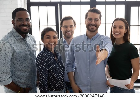 Happy millennial business group leader giving hand for shake. Photo Portrait of diverse professional team welcoming employees for hire and job. Lawyers or brokers offer deal to clients and customers Royalty-Free Stock Photo #2000247140