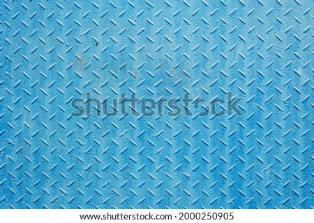 Texture of blue-colored corrugal iron. Light blue background.