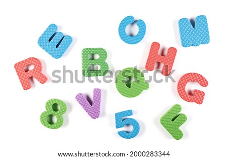 Colorful foam alphabet letters and numbers for children isolated on white background, top view