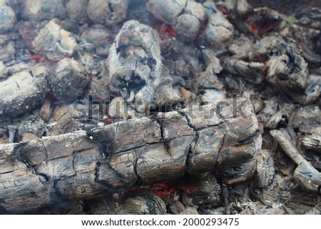background and ash charcoal gray blacks with red stained streaks close-up. The aftermath of the fire. Ashes. bonfire.