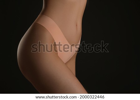 Closeup view of slim woman in underwear on black background, space for text. Cellulite problem concept
