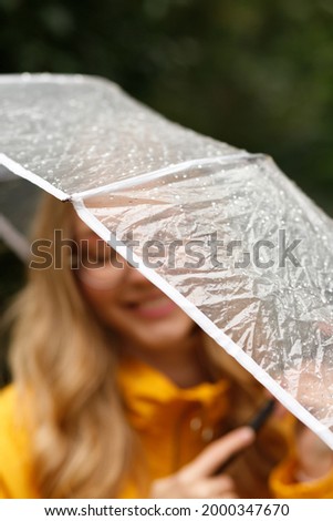 woman under an umbrella smiles close-up
