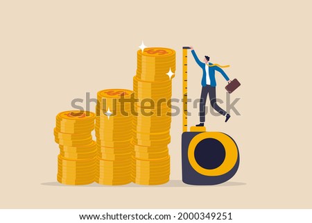Investment measurement or benchmark, ROI, return on investment, wealth monitoring with financial goal or target concept, businessman investor using measuring tape to measure money coins stack height. Royalty-Free Stock Photo #2000349251