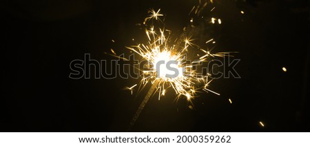 Bnner with burning sparkler on black background. Party, celebrity and new year concept