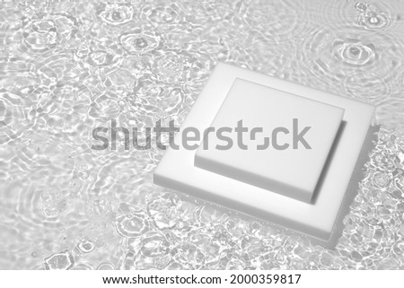Empty white square podium on transparent clear calm water texture with splashes and waves in sunlight. Abstract nature background for product presentation. Flat lay cosmetic mockup, copy space.