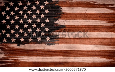 Vintage American flag on wooden texture. Vintage flag of USA on wood background.