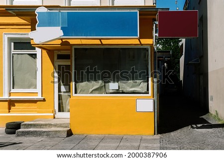 closed croque bistro or fast food restaurant, yellow house with locked windows, impact of the corona virus pandemic 2021 in Germany.