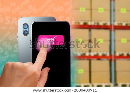 Online shopping concept. Online order processing concept. Order fulfillment process. Online store fulfillment technology. Smartphone on background of warehouse. Hand presses purchase icon on  phone