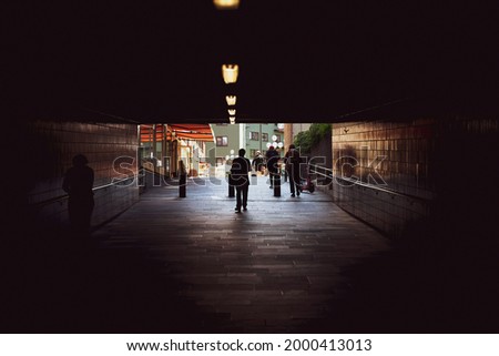 People coming out of the tunnel. From darkness into light. Urban photography in Oslo. Royalty-Free Stock Photo #2000413013
