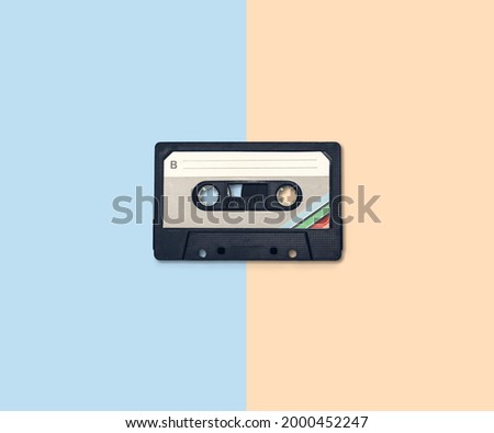 Old retro audio cassette on two color background