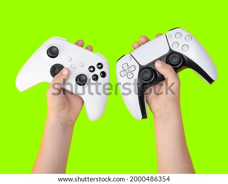 Kid holding game controllers with green background for cropping