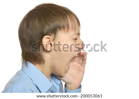 Young stressed boy scream on white background