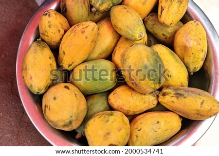 An exhibition selling ripe papayas in front of the administrative offices. 