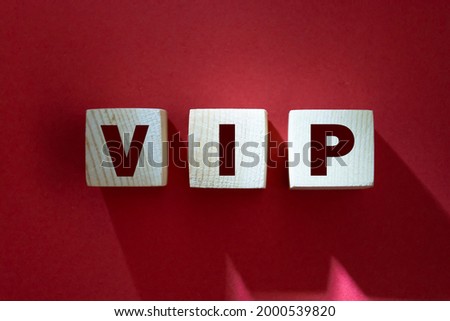 VIP Very Important Person text on wooden cubes on red. Business concept.