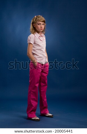 Young girl is posing on blue background