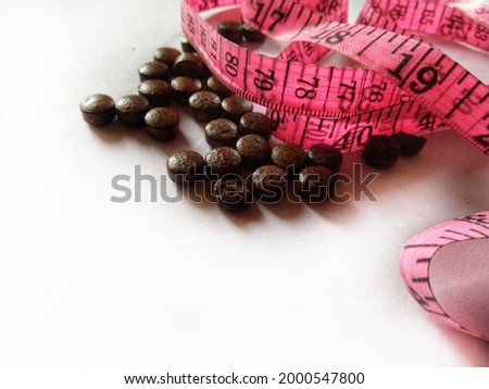 Diet pills and a tape measure. Weight loss ayurvedic treatment. Herbal medicine for Weight loss. supplements for weight loss. Weight loss concept.
 Royalty-Free Stock Photo #2000547800