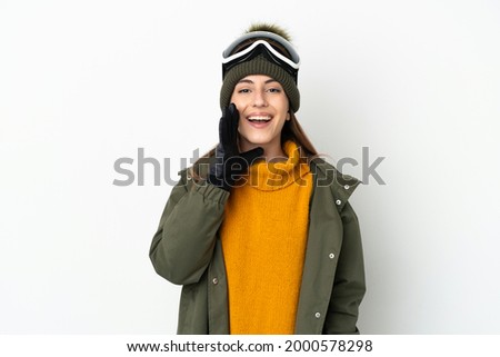 Skier caucasian woman with snowboarding glasses isolated on white background shouting with mouth wide open