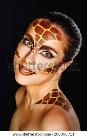 Close portrait of a young attractive girl with a make-up of an animal shot in a studio