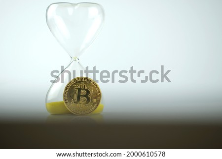 Bitcoin coin with an hourglass. The rapid growth of the cryptocurrency