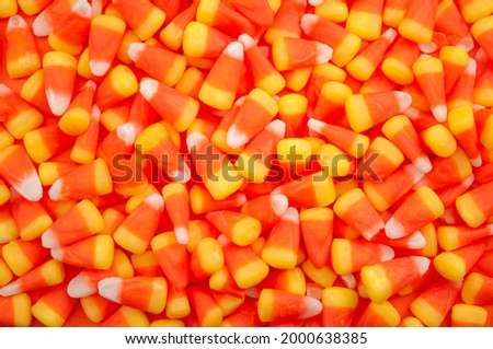 Nostalgic American tradition, iconic trick or treat sweets and Halloween backgrounds concept with full frame of many candy corn pieces with copy space Royalty-Free Stock Photo #2000638385